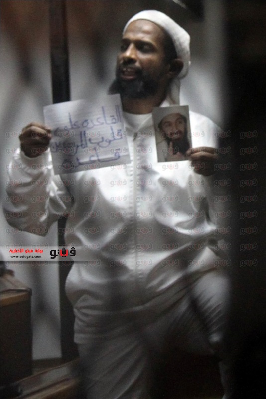 Jamal holding photo of bin Laden.jpg