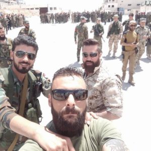 Quds Brigade combatant with Russian officers in the back, posted in June 2016. 